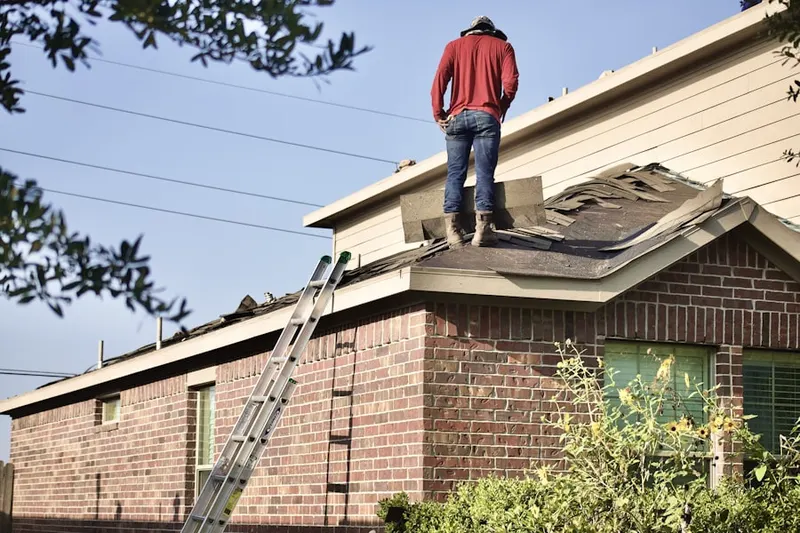 Professional roofer working on a residential roof in Palm Desert